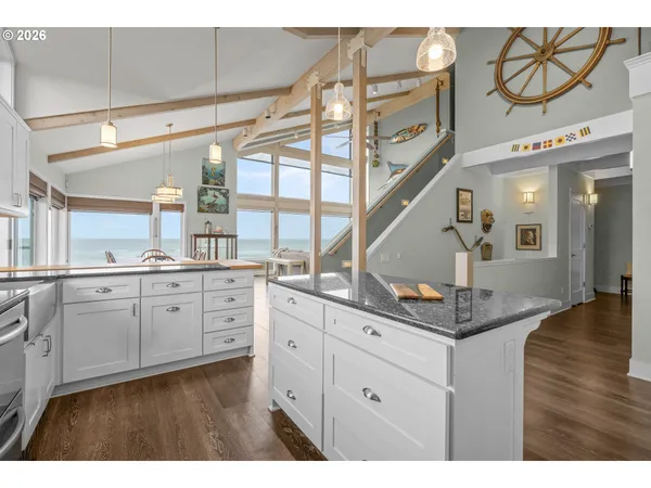 a bathroom with a granite countertop sink toilet a mirror and shower