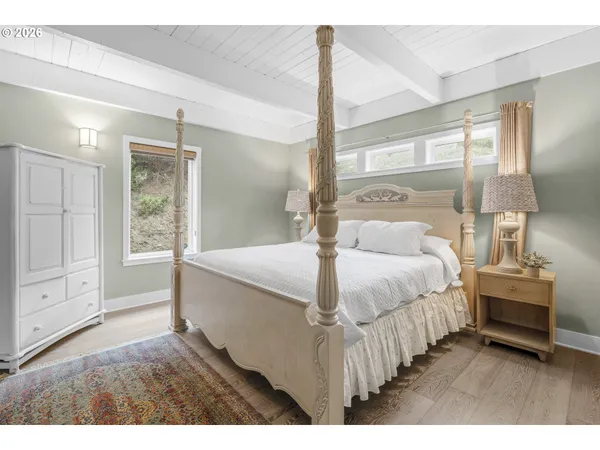 a bedroom with a large bed and a window