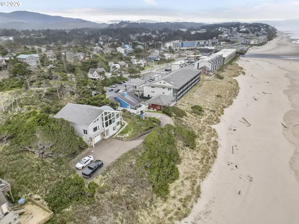 an aerial view of a house with a mountain