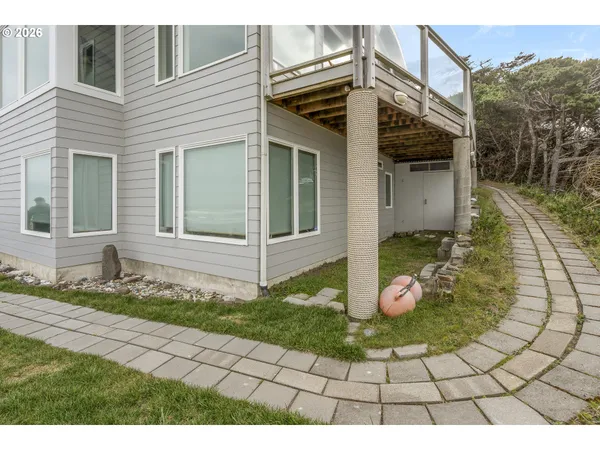 an aerial view of a house with outdoor space and a lake view