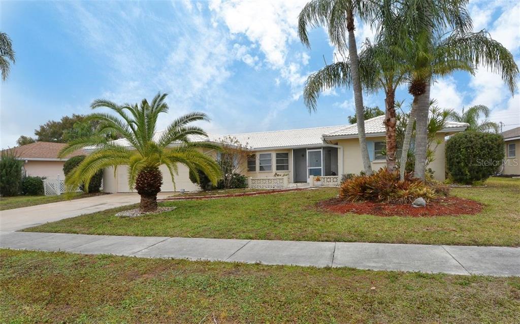 3011 Post Road Sarasota, FL 34231 - Photo 1 of 1 a front view of a house with a garden and entryway