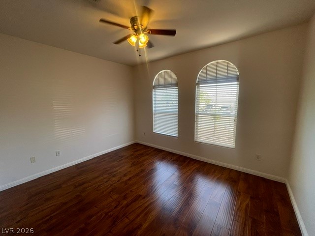 3047 Hickory Valley Road Henderson, NV 89052 - Photo 9 of 21 Rich hardwood floors complement arched windows in this versatile living space.
