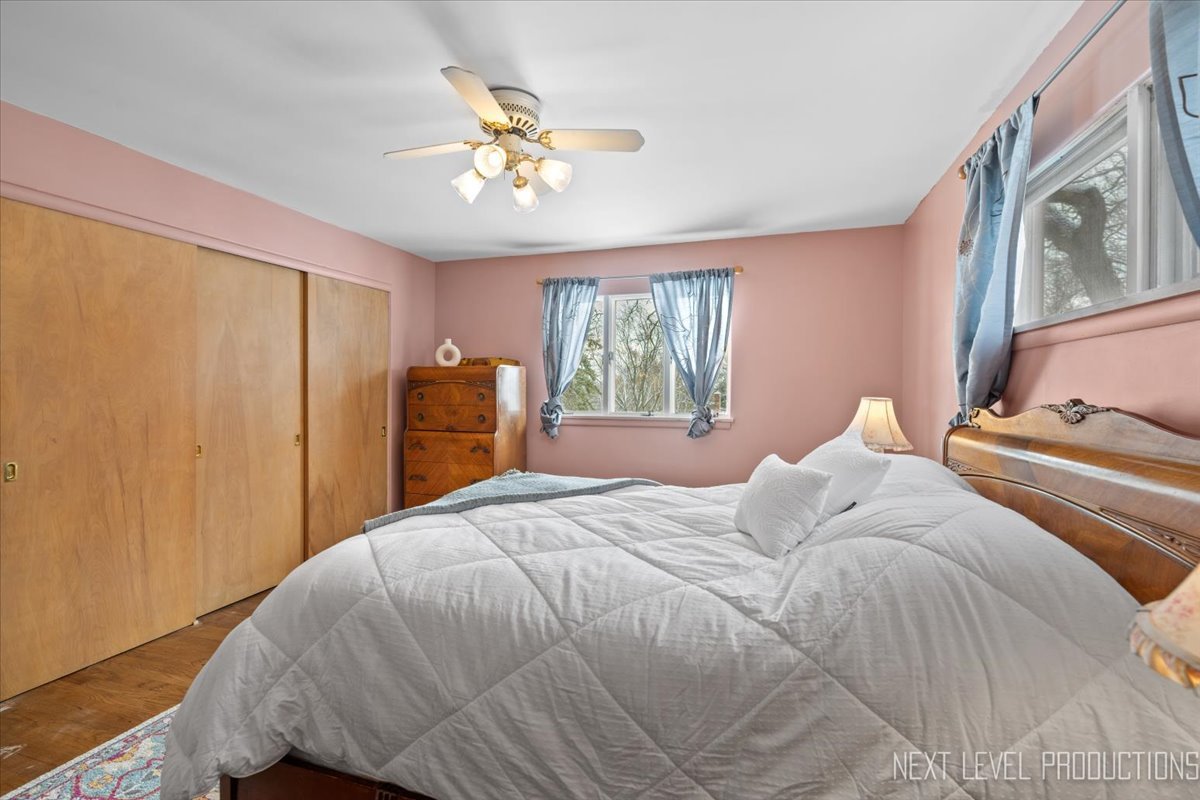 38W443 Sunset Drive St. Charles, IL 60175 - Photo 18 of 33 a bedroom with a bed and a chandelier