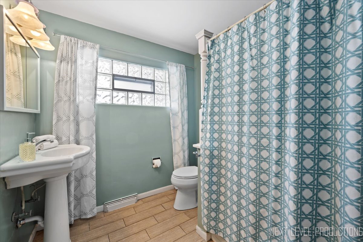 38W443 Sunset Drive St. Charles, IL 60175 - Photo 19 of 33 a bathroom with a sink a toilet and a window