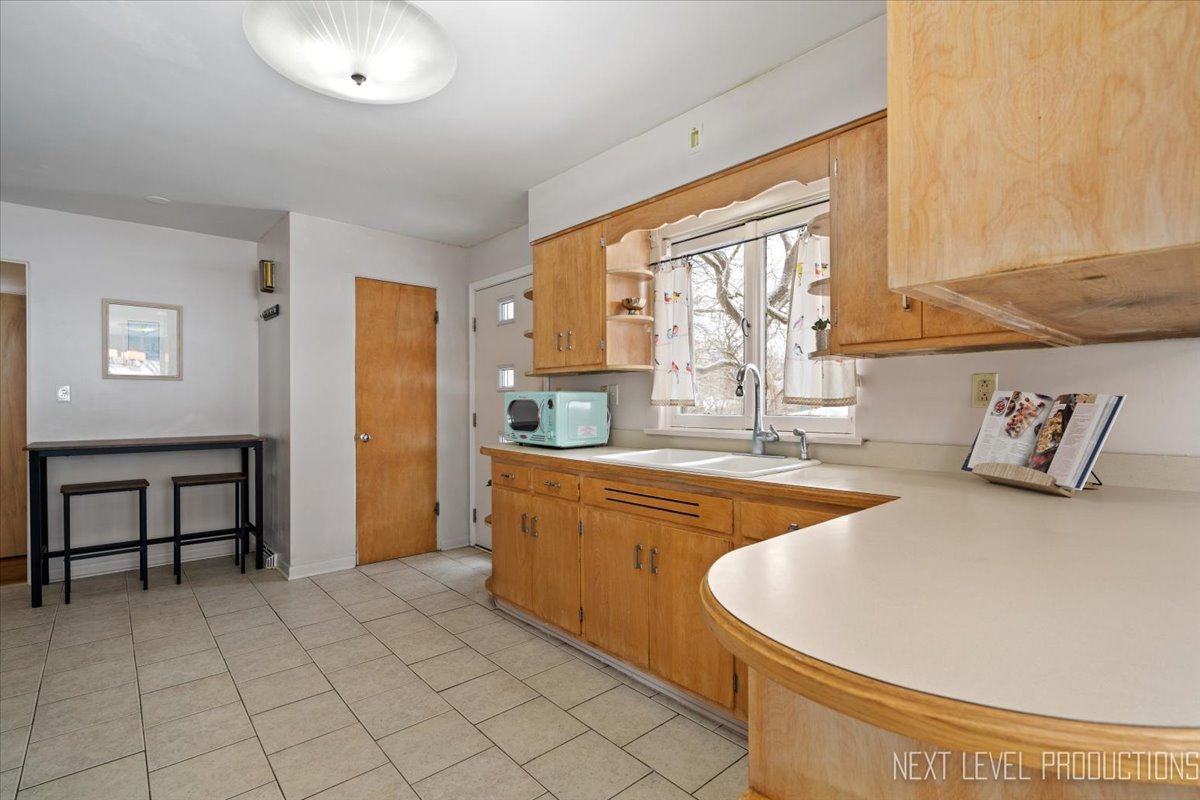 38W443 Sunset Drive St. Charles, IL 60175 - Photo 6 of 33 a large white kitchen with a large window