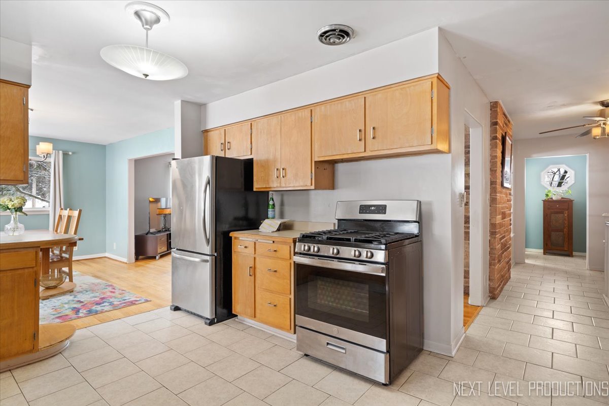 38W443 Sunset Drive St. Charles, IL 60175 - Photo 7 of 33 a kitchen with refrigerator and cabinets
