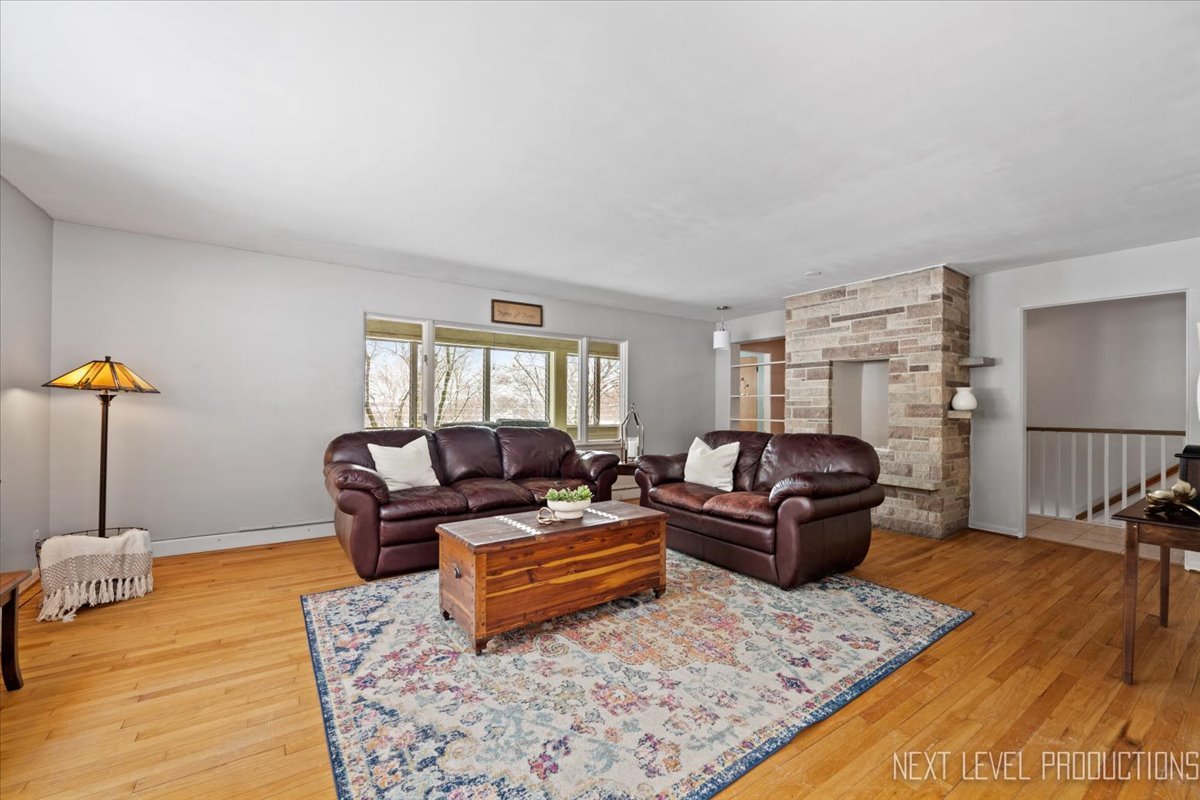 38W443 Sunset Drive St. Charles, IL 60175 - Photo 10 of 33 a living room with furniture wooden floor and a table
