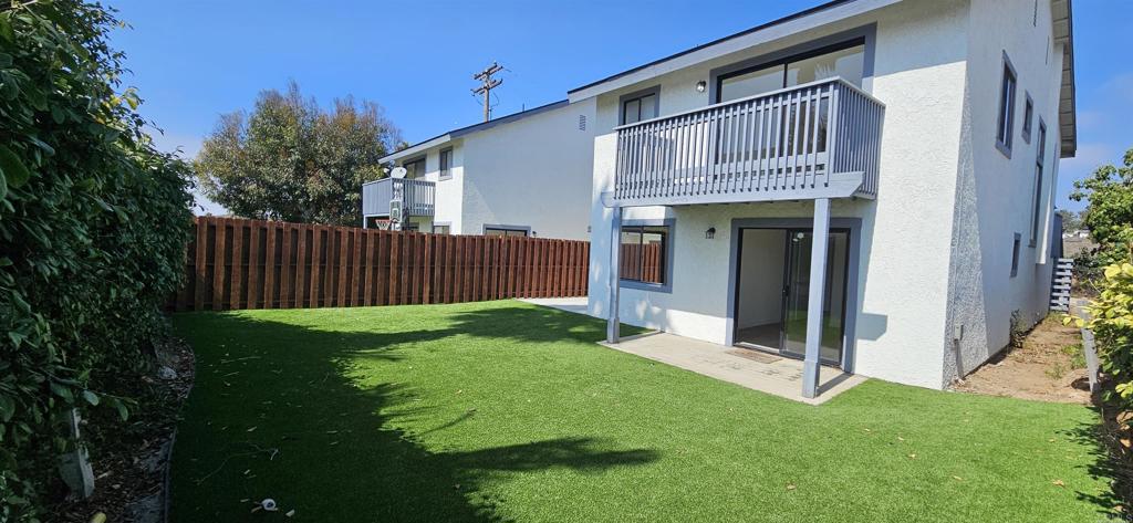 658-660 Santa Fe Drive Encinitas, CA 92024 - Photo 1 of 14 a view of backyard with potted plants and wooden fence