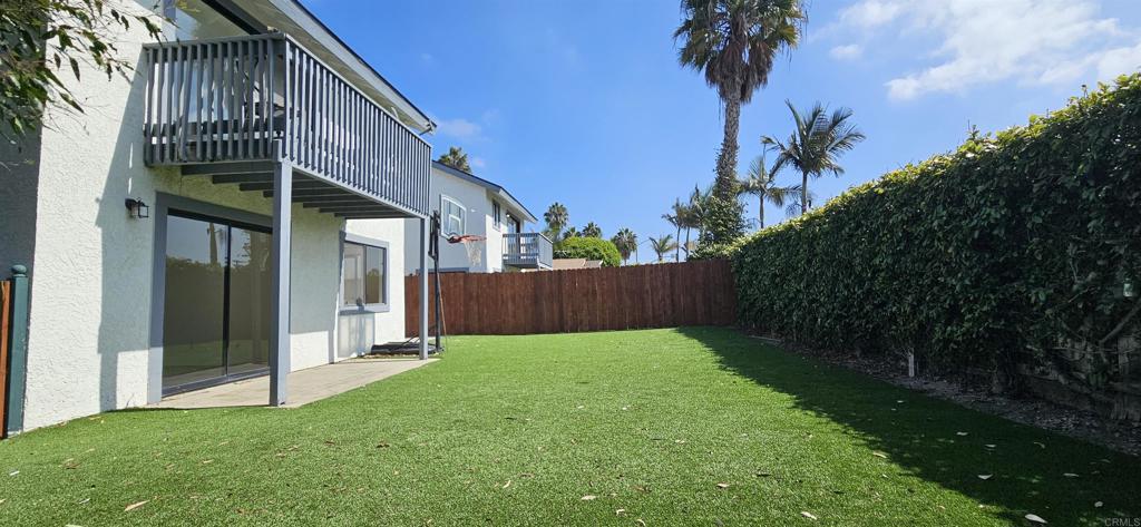 658-660 Santa Fe Drive Encinitas, CA 92024 - Photo 4 of 14 a view of backyard with potted plants and wooden fence