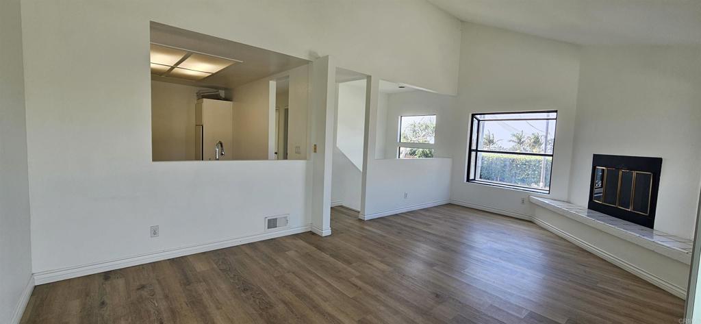 658-660 Santa Fe Drive Encinitas, CA 92024 - Photo 5 of 14 an empty room with wooden floor and windows