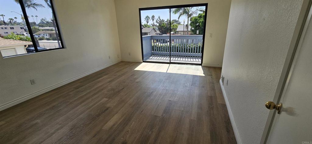 658-660 Santa Fe Drive Encinitas, CA 92024 - Photo 10 of 14 an empty room with wooden floor and windows