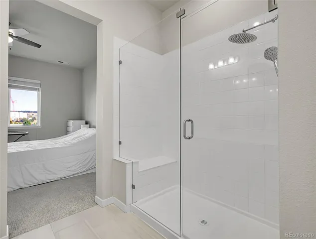 a spacious bathroom with a bathtub and shower