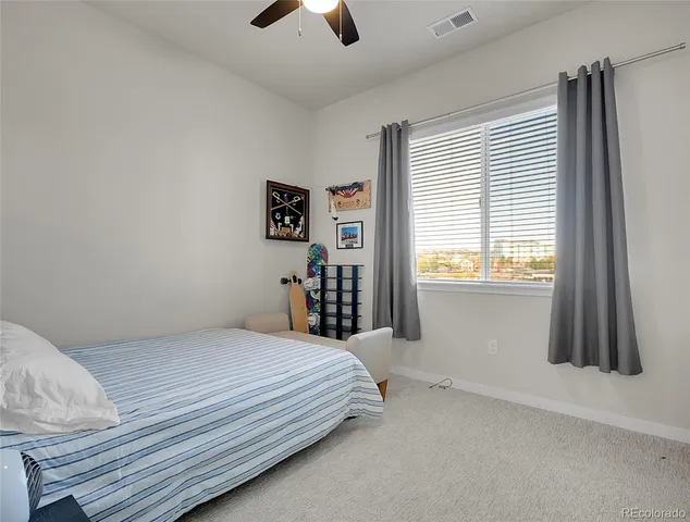 a bedroom with a bed and a flat tv screen