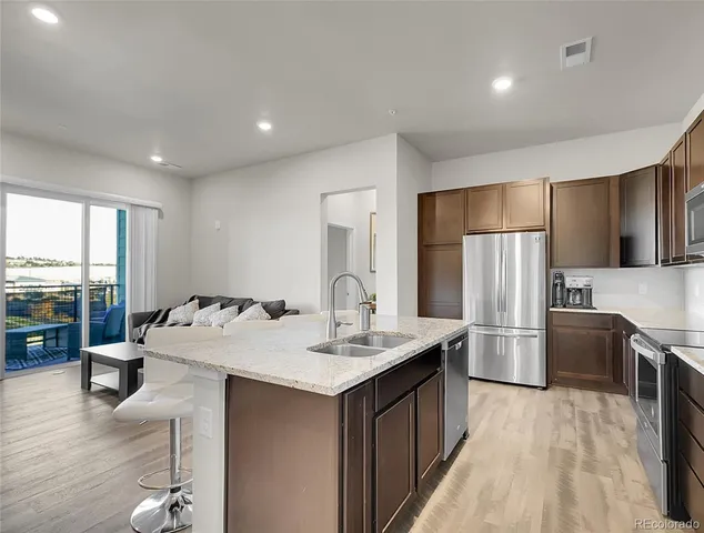 a kitchen with refrigerator cabinets and wooden floor