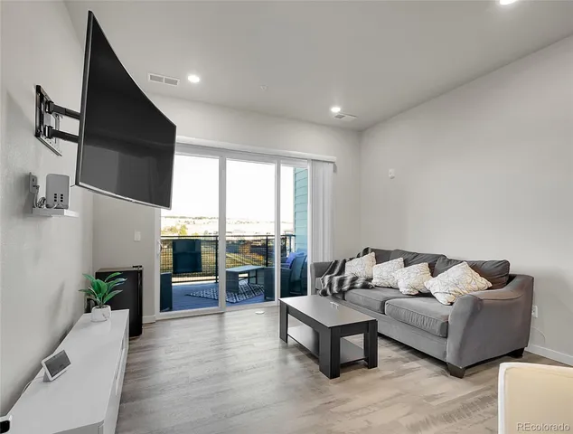 a living room with furniture and large windows