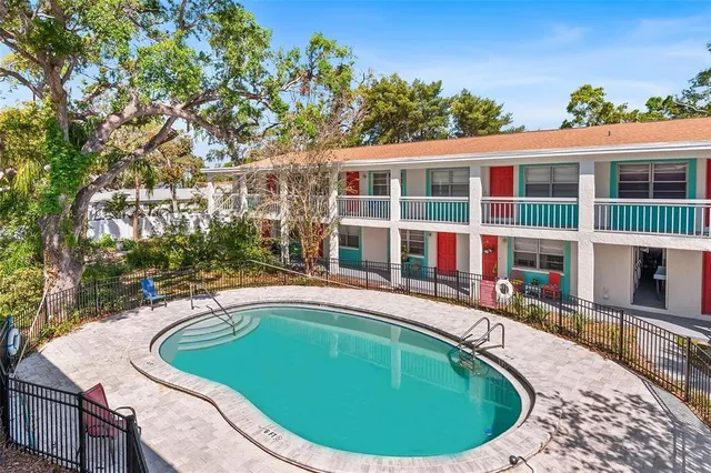 a view of a house with swimming pool and sitting area