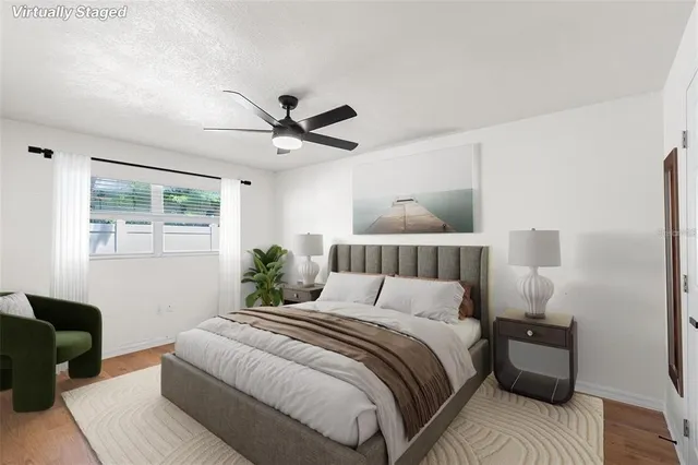 a bedroom with a large bed and a window