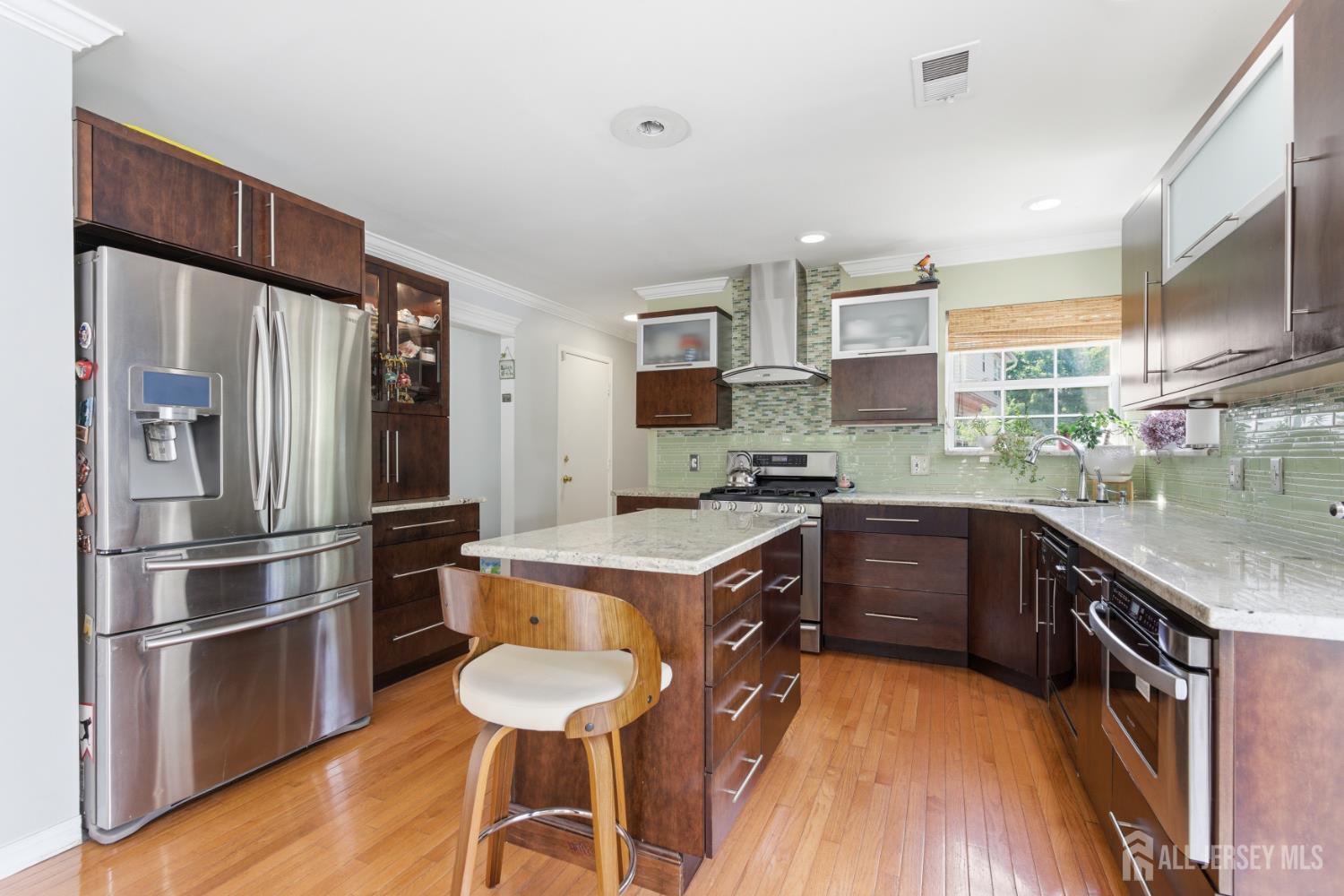 26 Alexis Lane Edison, NJ 08820 - Photo 13 of 39 a kitchen with a refrigerator a sink and a stove top oven