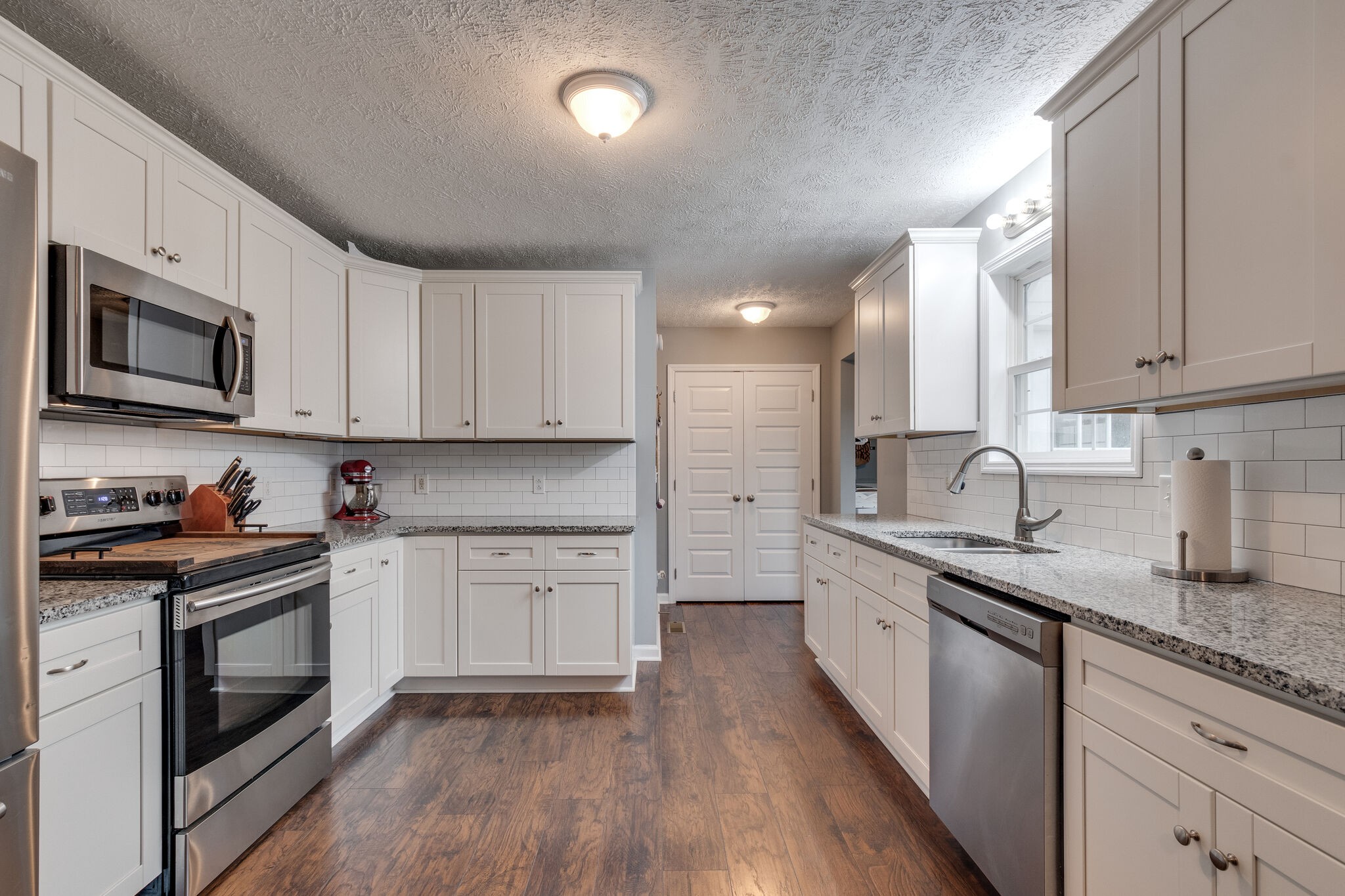 7593 Beech Hill Road Pulaski, TN 38478 - Photo 15 of 40 a kitchen with granite countertop cabinets stainless steel appliances a sink and wooden floor