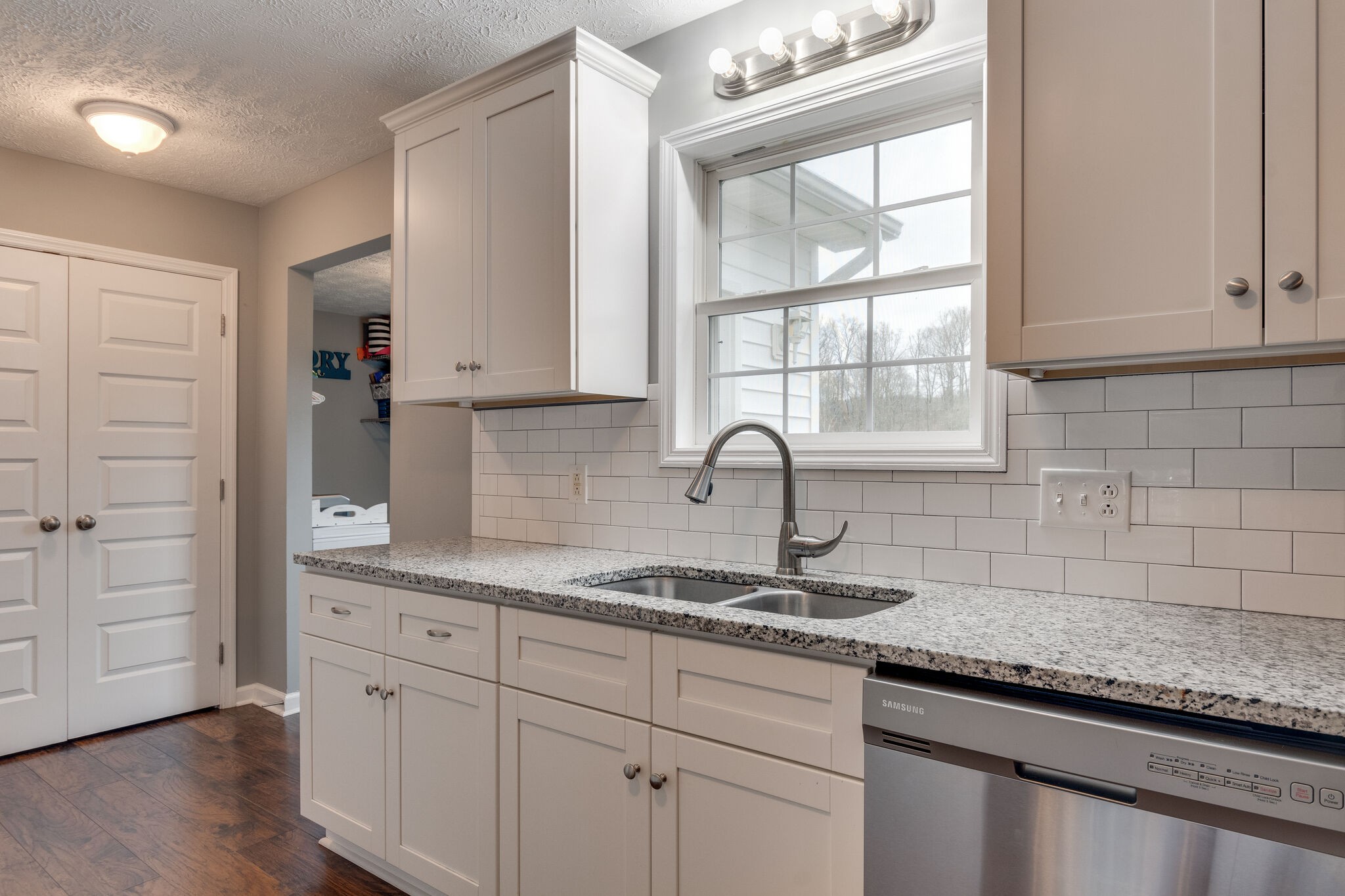 7593 Beech Hill Road Pulaski, TN 38478 - Photo 16 of 40 a kitchen with granite countertop white cabinets and a window