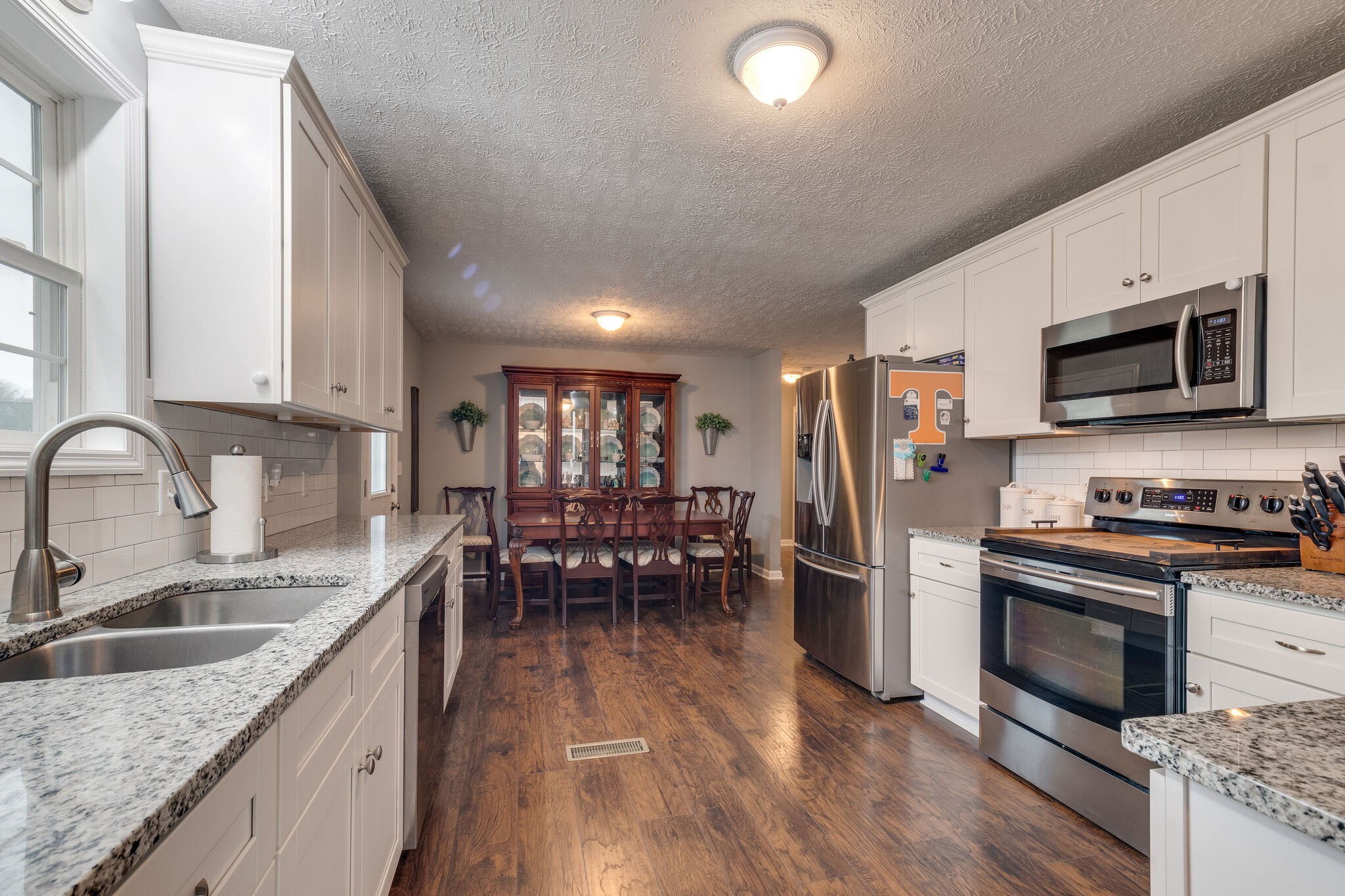 7593 Beech Hill Road Pulaski, TN 38478 - Photo 17 of 40 a kitchen with stainless steel appliances granite countertop a sink dishwasher stove top oven and refrigerator