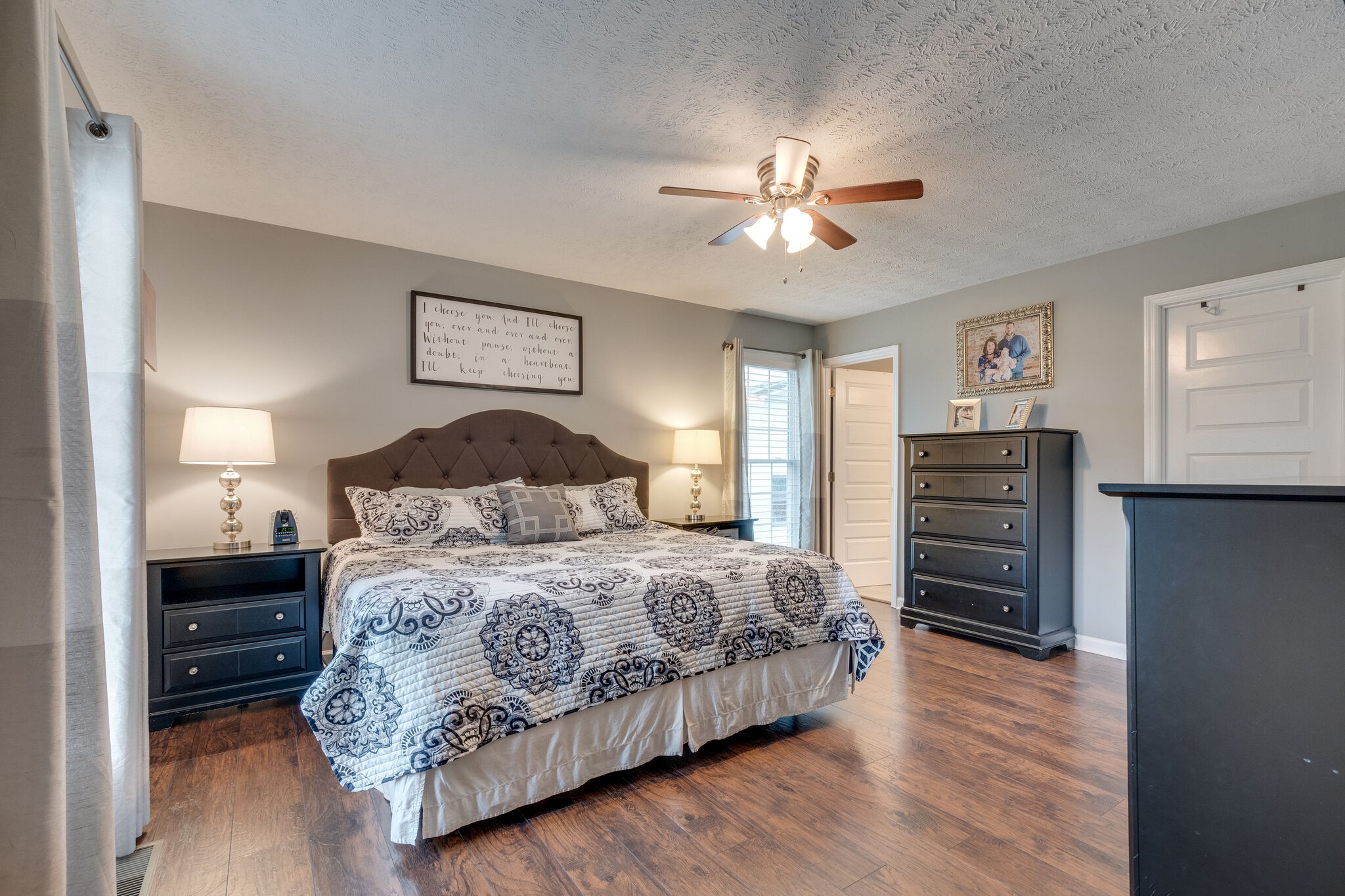 7593 Beech Hill Road Pulaski, TN 38478 - Photo 18 of 40 a bedroom with a bed and a chandelier
