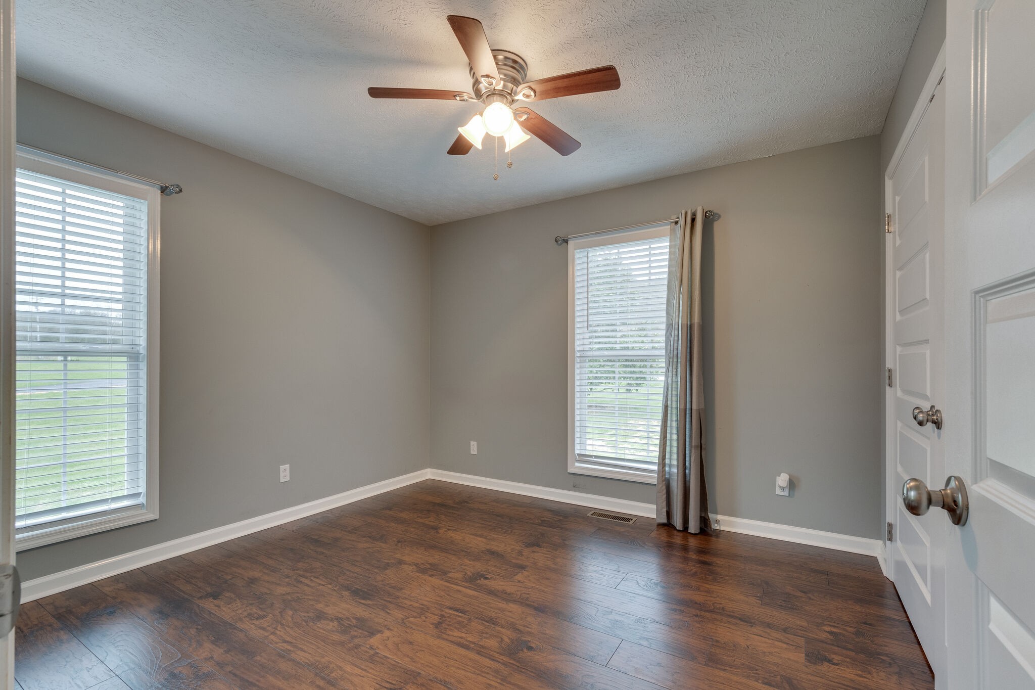 7593 Beech Hill Road Pulaski, TN 38478 - Photo 23 of 40 an empty room with wooden floor and windows