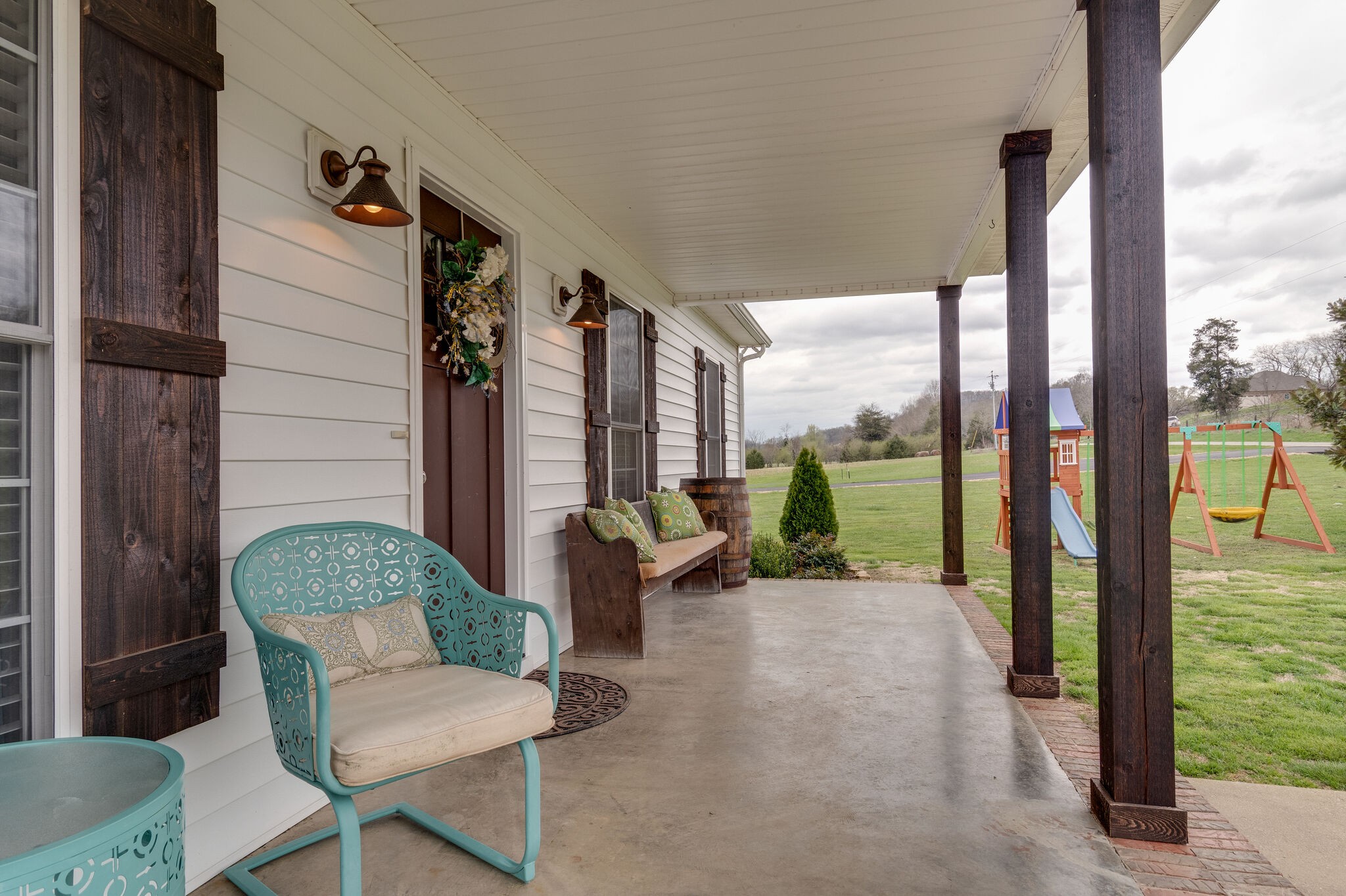 7593 Beech Hill Road Pulaski, TN 38478 - Photo 7 of 40 a balcony with chairs and a potted plant