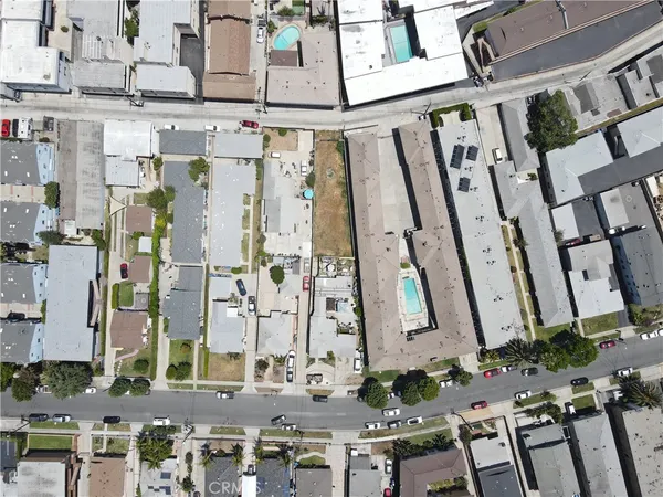 a aerial view of multi story residential apartment building with yard