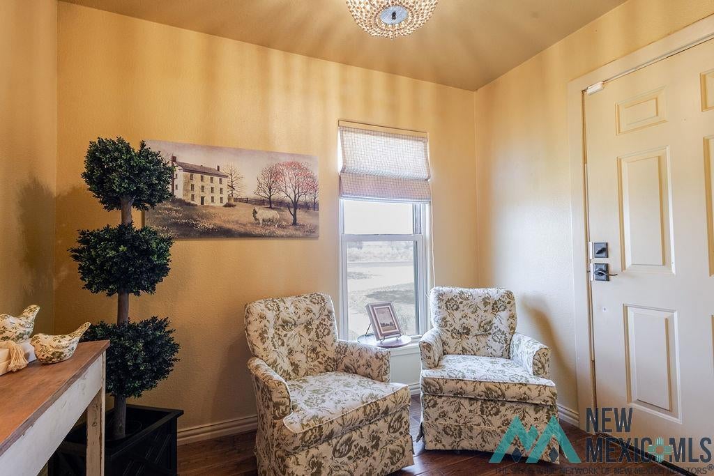 1131 Curry Road North Clovis, NM 88101 - Photo 2 of 69 Entryway featuring a panel door, decorative ceiling light fixture, and wood-finish flooring