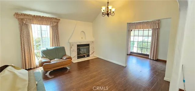 a living room with furniture fireplace and wooden floor