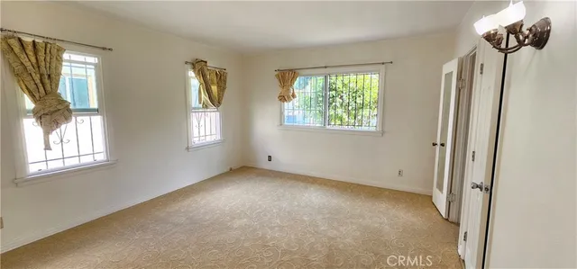 a view of an empty room with windows