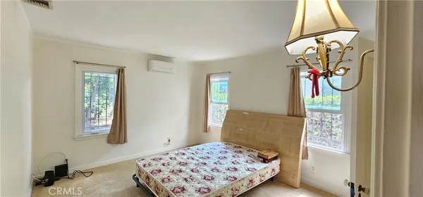 a bedroom with a bed and a chandelier