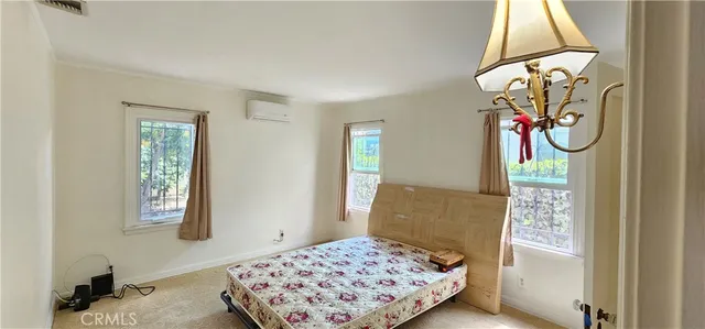 a bedroom with a bed and a chandelier