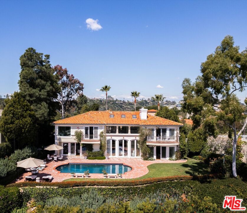 a front view of a house with a yard swimming pool and outdoor seating