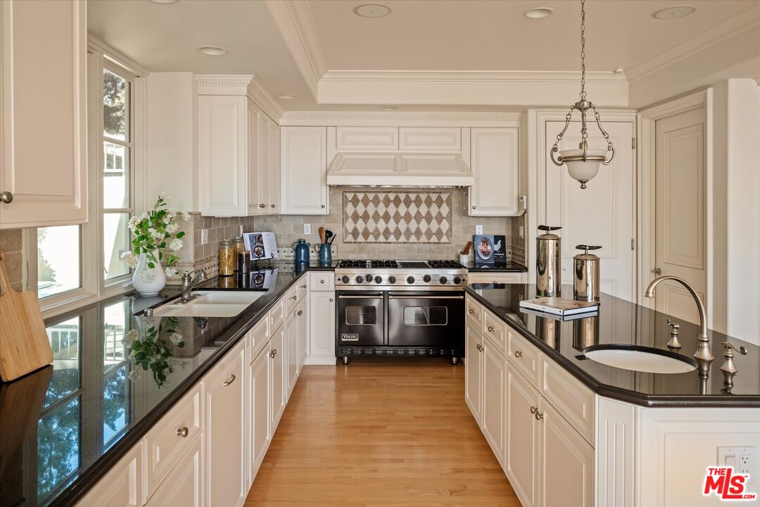 10814 Savona Road Los Angeles, CA 90077 - Photo 11 of 37 a kitchen with kitchen island granite countertop a sink stove and refrigerator