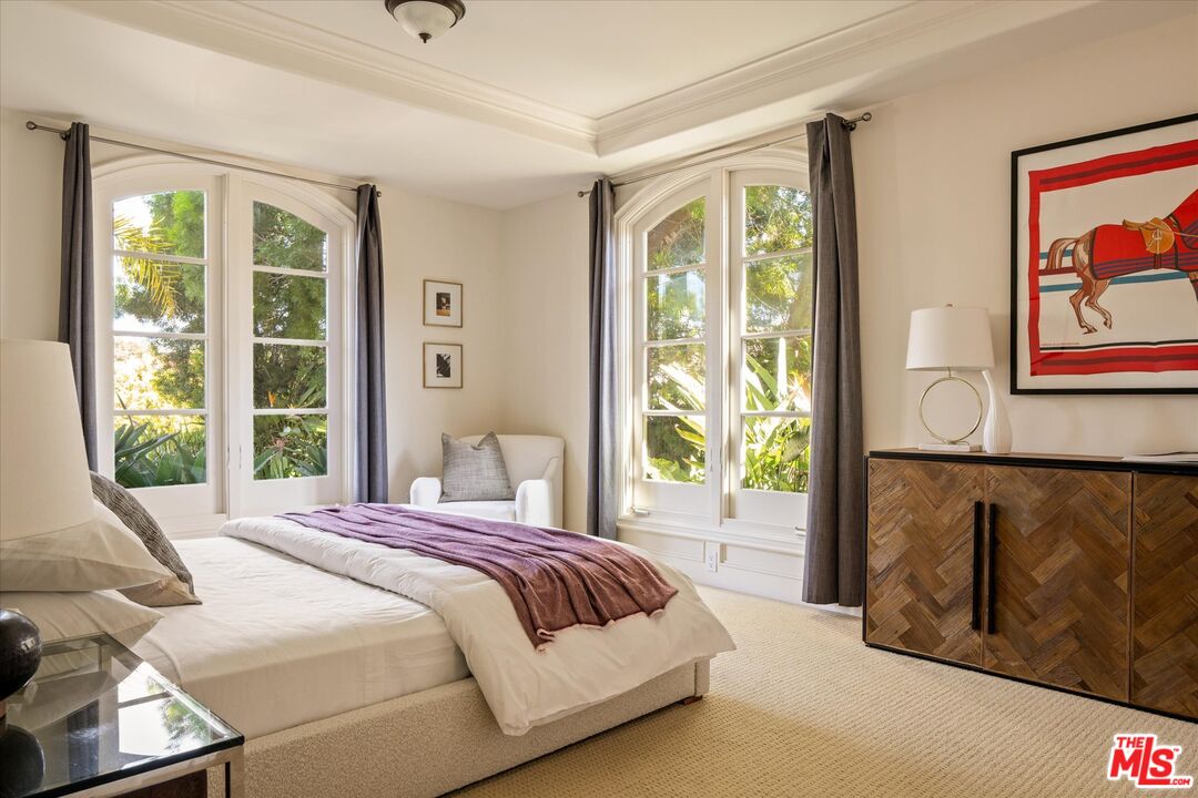 10814 Savona Road Los Angeles, CA 90077 - Photo 12 of 37 a bedroom with a large bed and a window