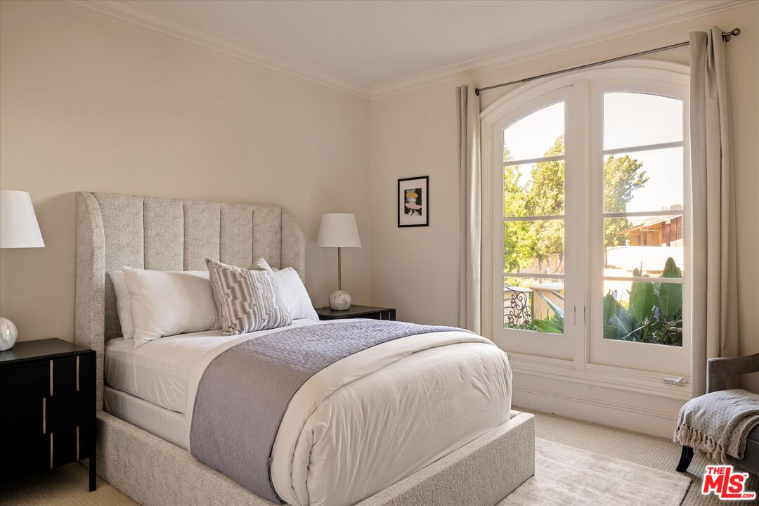 10814 Savona Road Los Angeles, CA 90077 - Photo 13 of 37 a bed sitting in a bedroom next to a window