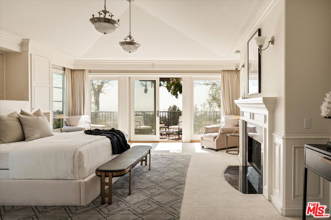 10814 Savona Road Los Angeles, CA 90077 - Photo 16 of 37 a bedroom with a bed and large windows