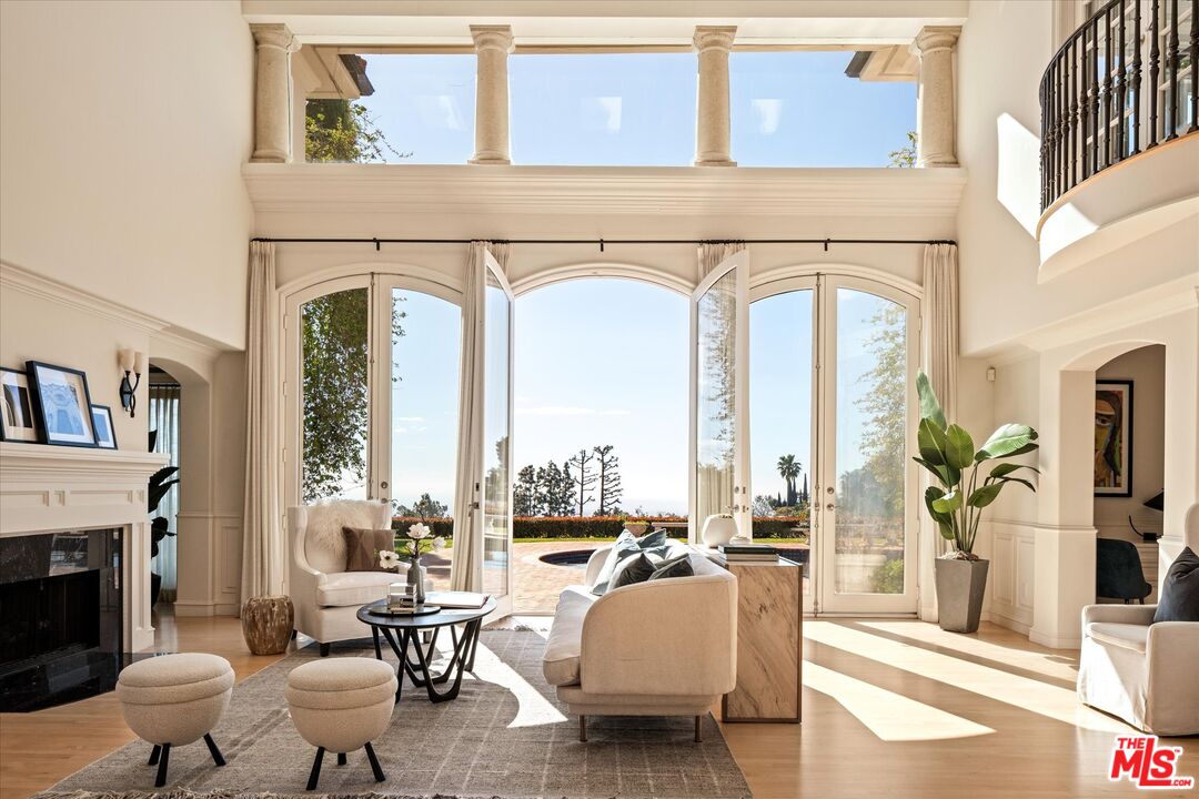 10814 Savona Road Los Angeles, CA 90077 - Photo 2 of 37 a living room with furniture or fireplace and a potted plant