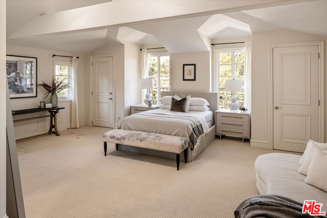 10814 Savona Road Los Angeles, CA 90077 - Photo 21 of 37 a bedroom with a bed couch and a window