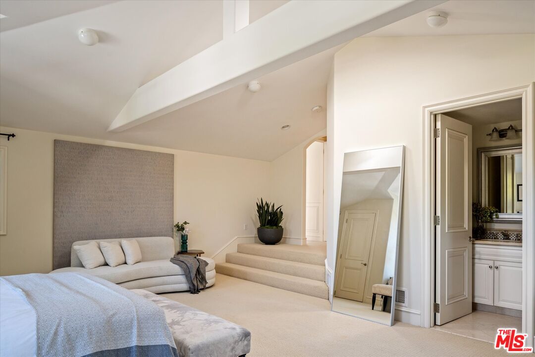 10814 Savona Road Los Angeles, CA 90077 - Photo 22 of 37 a bedroom with a bed and gym equipment