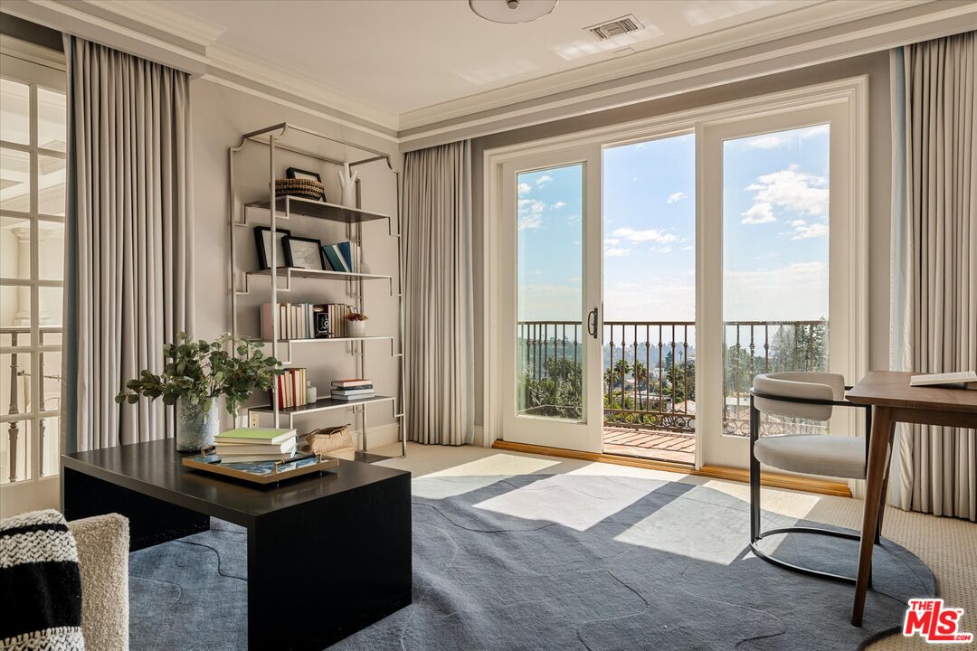 10814 Savona Road Los Angeles, CA 90077 - Photo 27 of 37 a living room with furniture and a floor to ceiling window