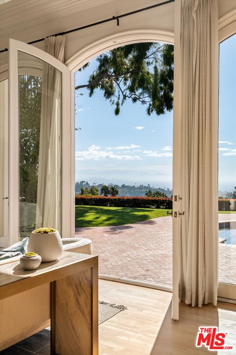 10814 Savona Road Los Angeles, CA 90077 - Photo 3 of 37 a view of a balcony with lake view and a floor to ceiling window