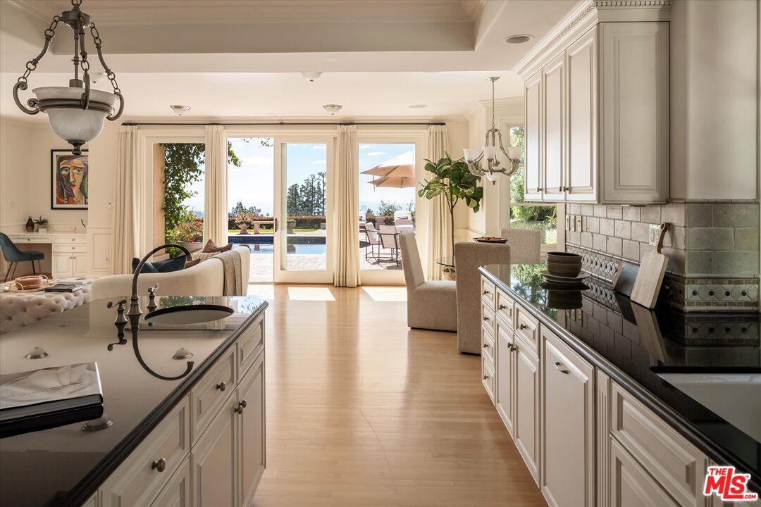 10814 Savona Road Los Angeles, CA 90077 - Photo 10 of 37 a kitchen with sink a stove and cabinets