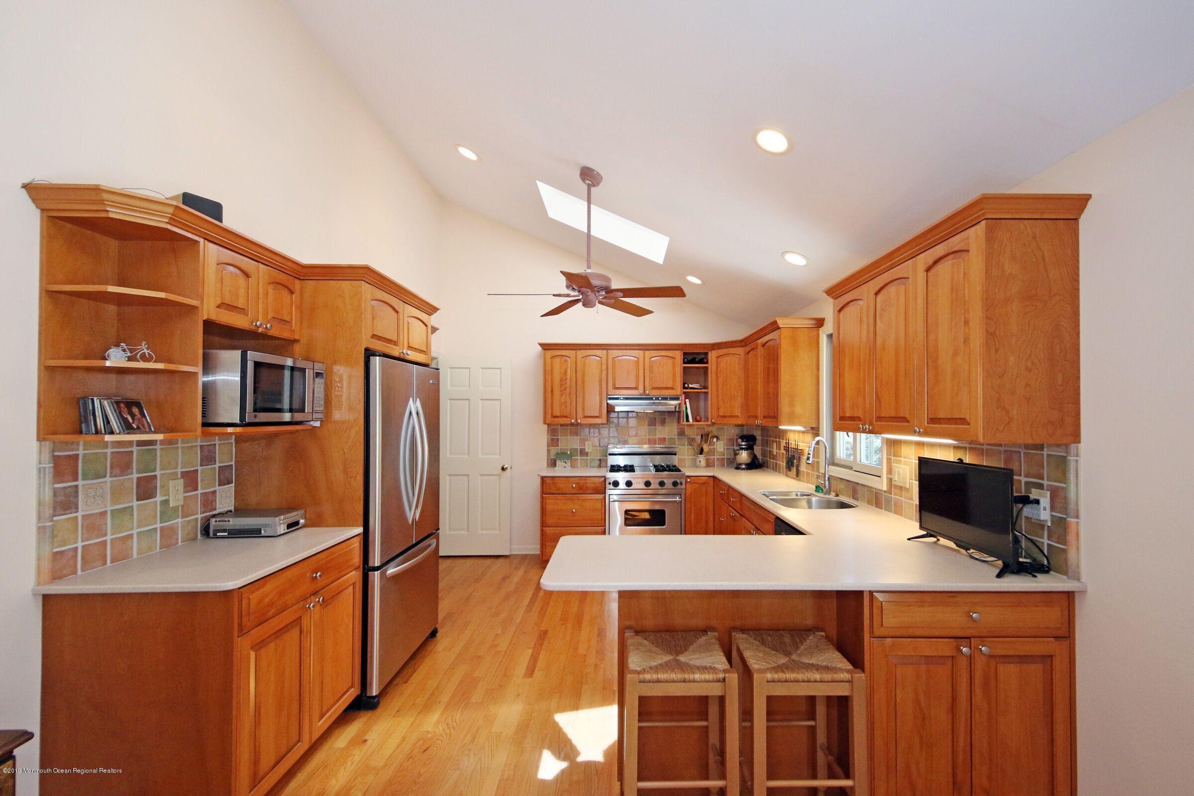 81 Mallard Road Middletown, NJ 07748 - Photo 13 of 25 a kitchen with stainless steel appliances a stove a sink a refrigerator and cabinets