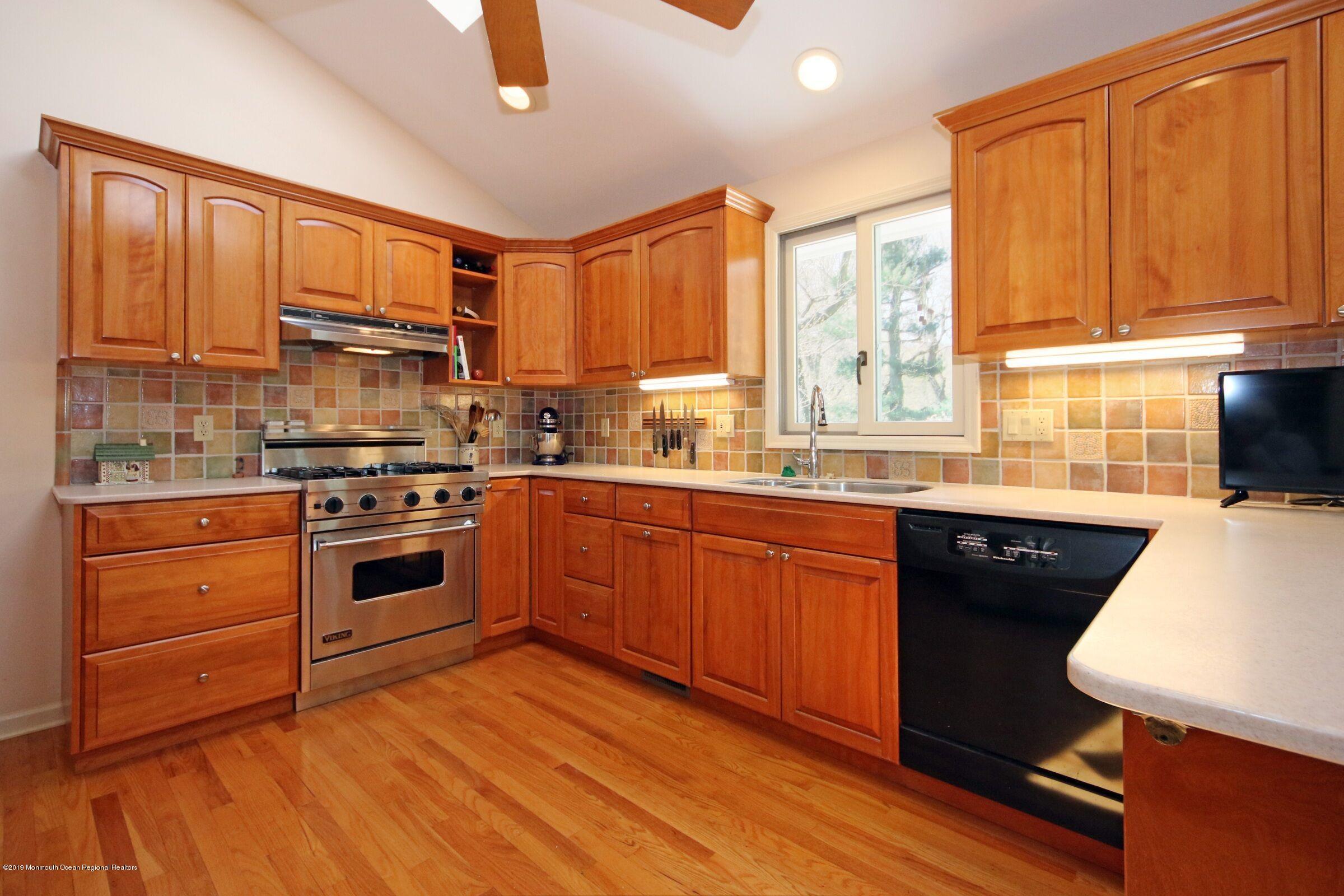 81 Mallard Road Middletown, NJ 07748 - Photo 10 of 25 a kitchen with stainless steel appliances granite countertop a stove a sink dishwasher and a microwave oven with cabinets