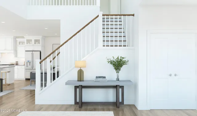 a view of staircase with white walls and a painting on the wall