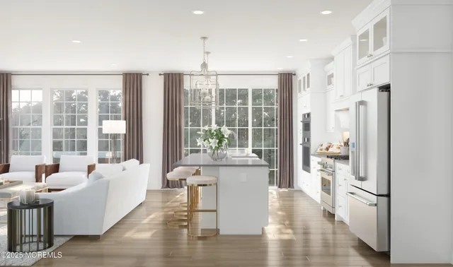 a living room with furniture large windows and wooden floor