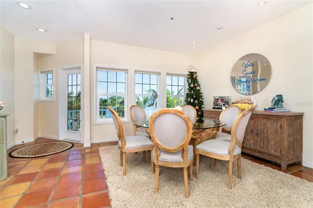 a living room with furniture kitchen view and a large window